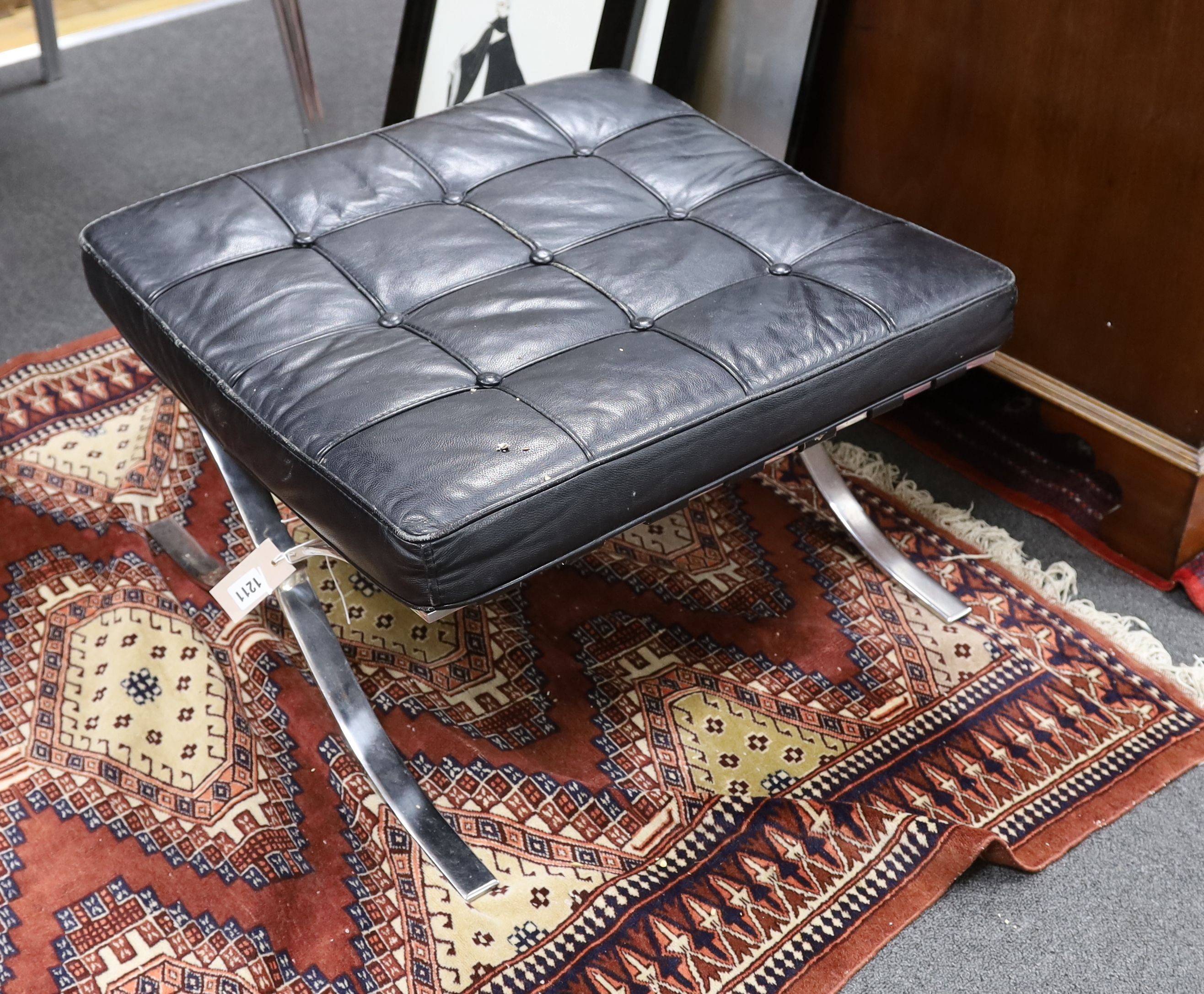 A Barcelona style black leather and chrome footstool, length 64cm, depth 57cm, height 37cm